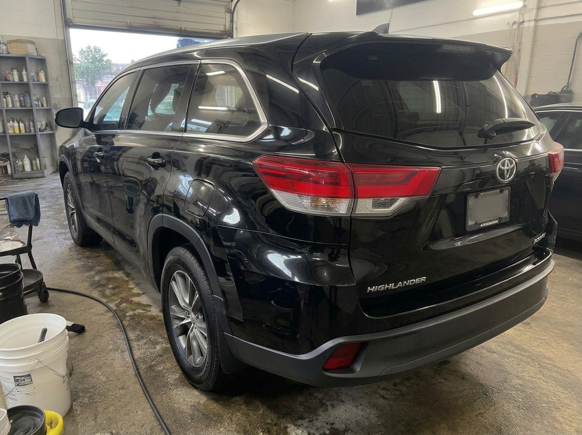 Same black SUV after ceramic coating with clean glossy paint and sharp reflections
