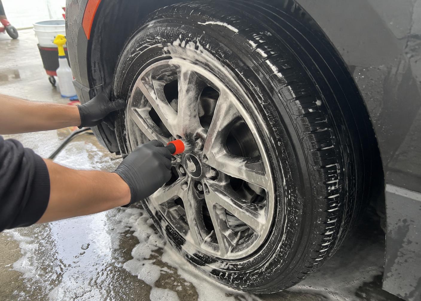 Wheel and tire being detailed with a soft brush