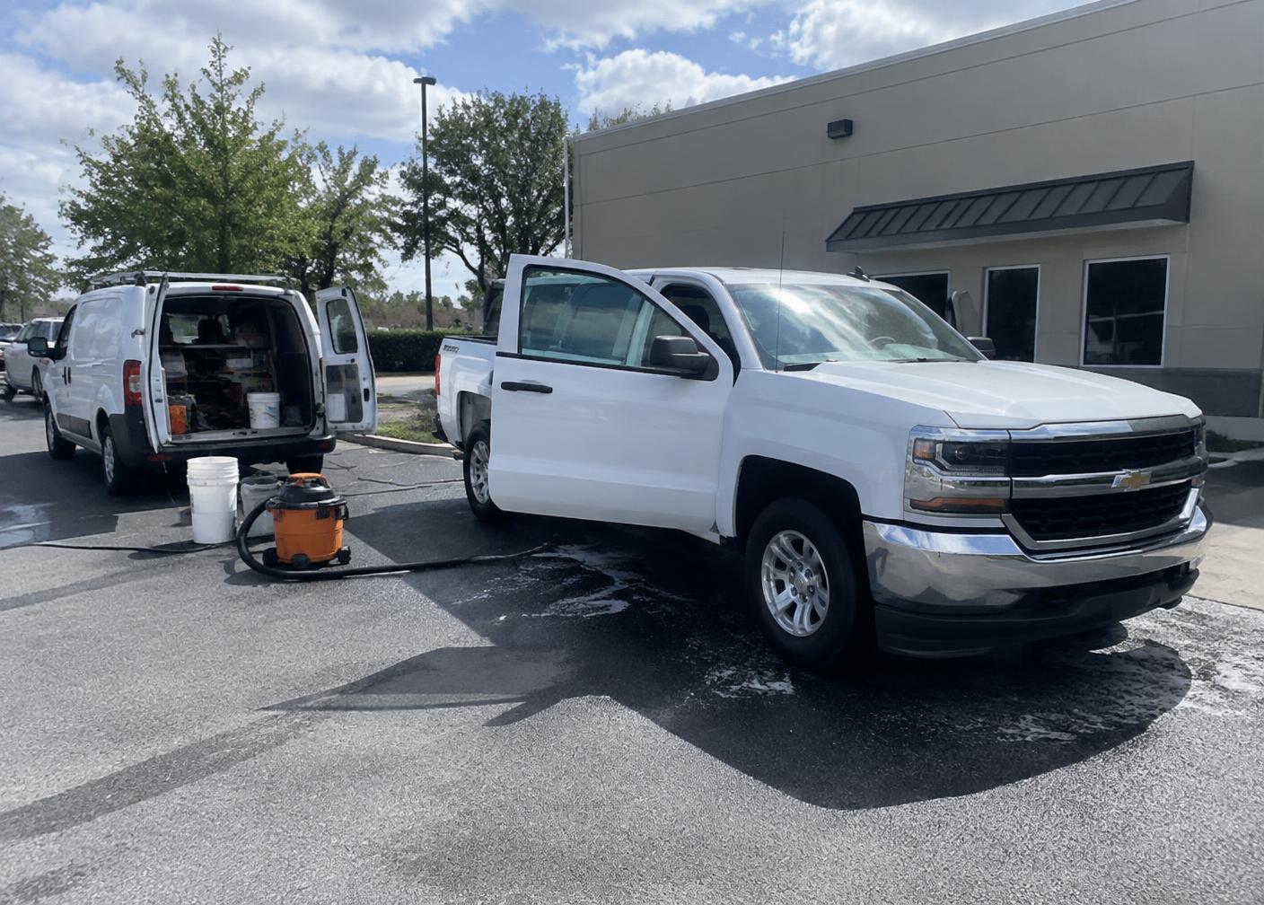 Work truck receiving mobile detailing at a workplace
