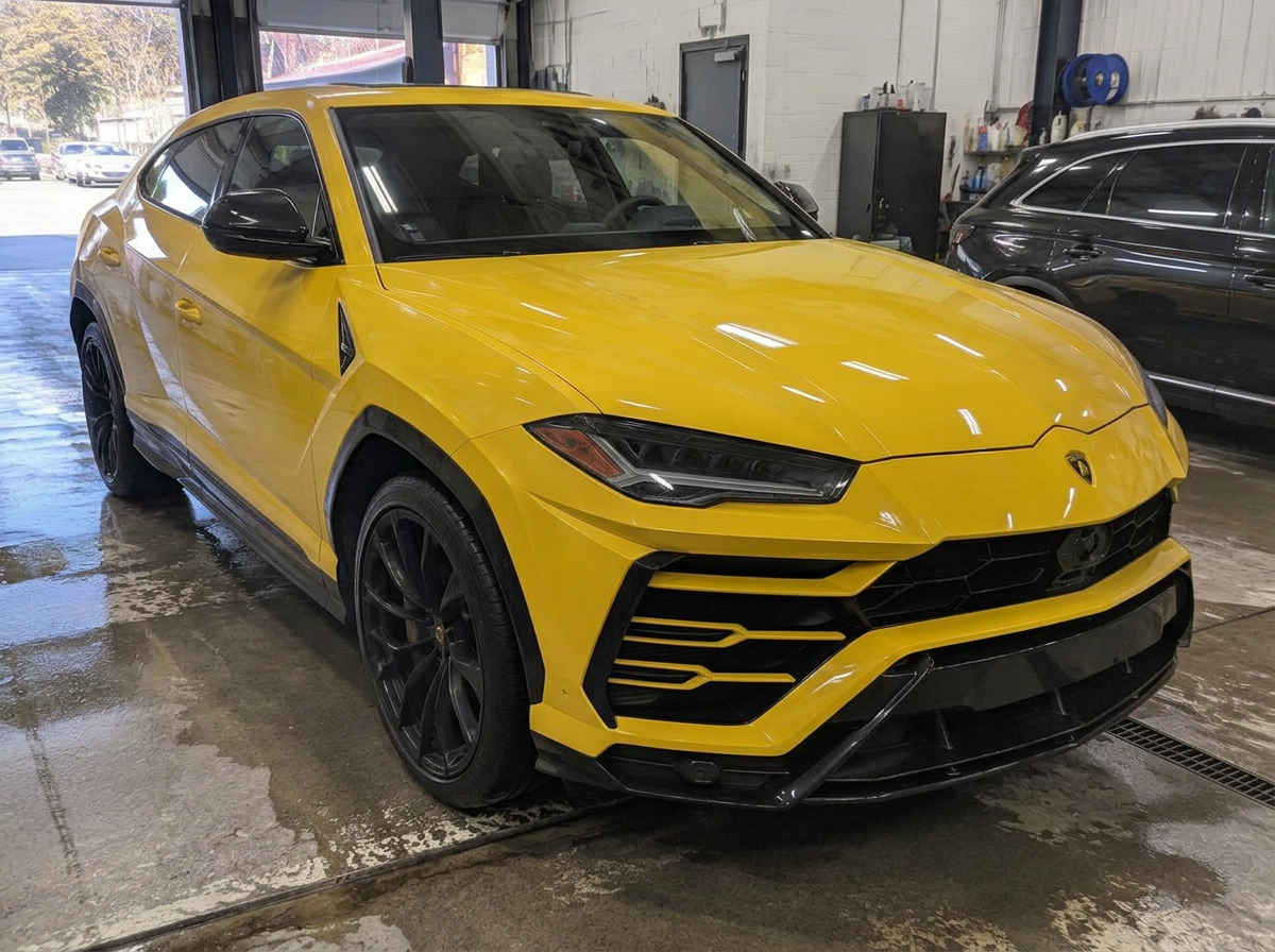 Same yellow Lamborghini Urus after paint protection film installation with a clean glossy finish