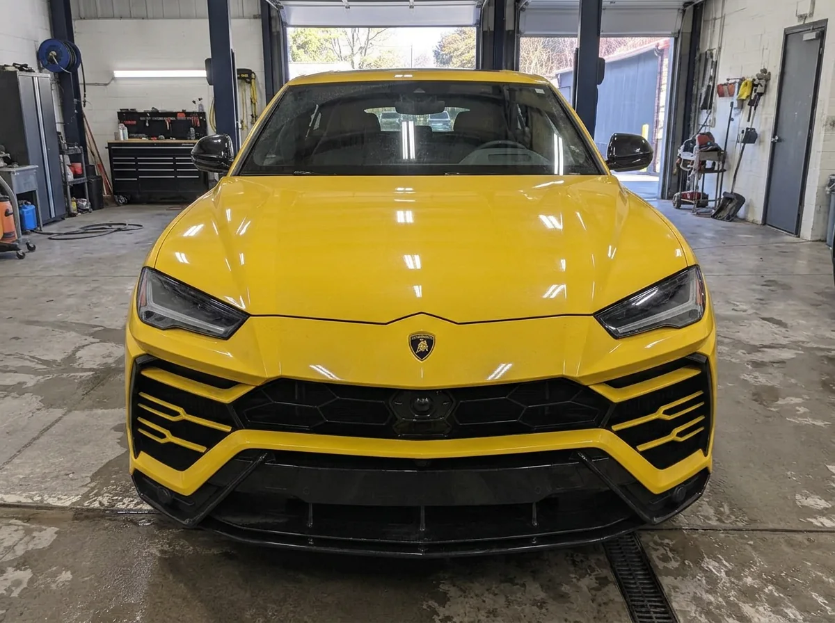 Yellow Lamborghini Urus in the shop before paint protection film installation
