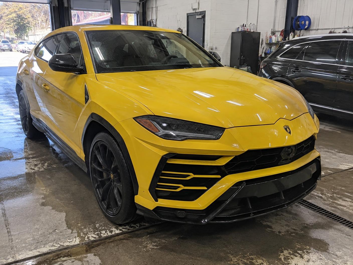 Yellow Lamborghini Urus in the shop before paint protection film installation
