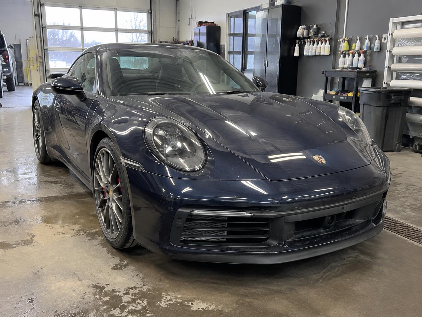 Dark blue Porsche 911 in the shop before paint protection film installation
