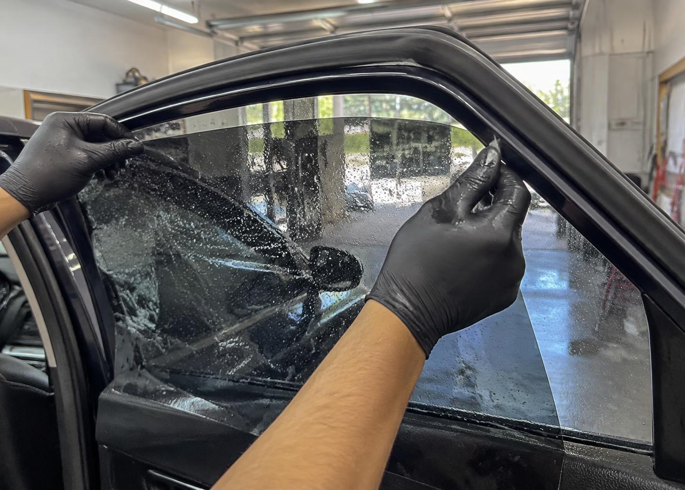 Automotive window film aligned on wet side glass