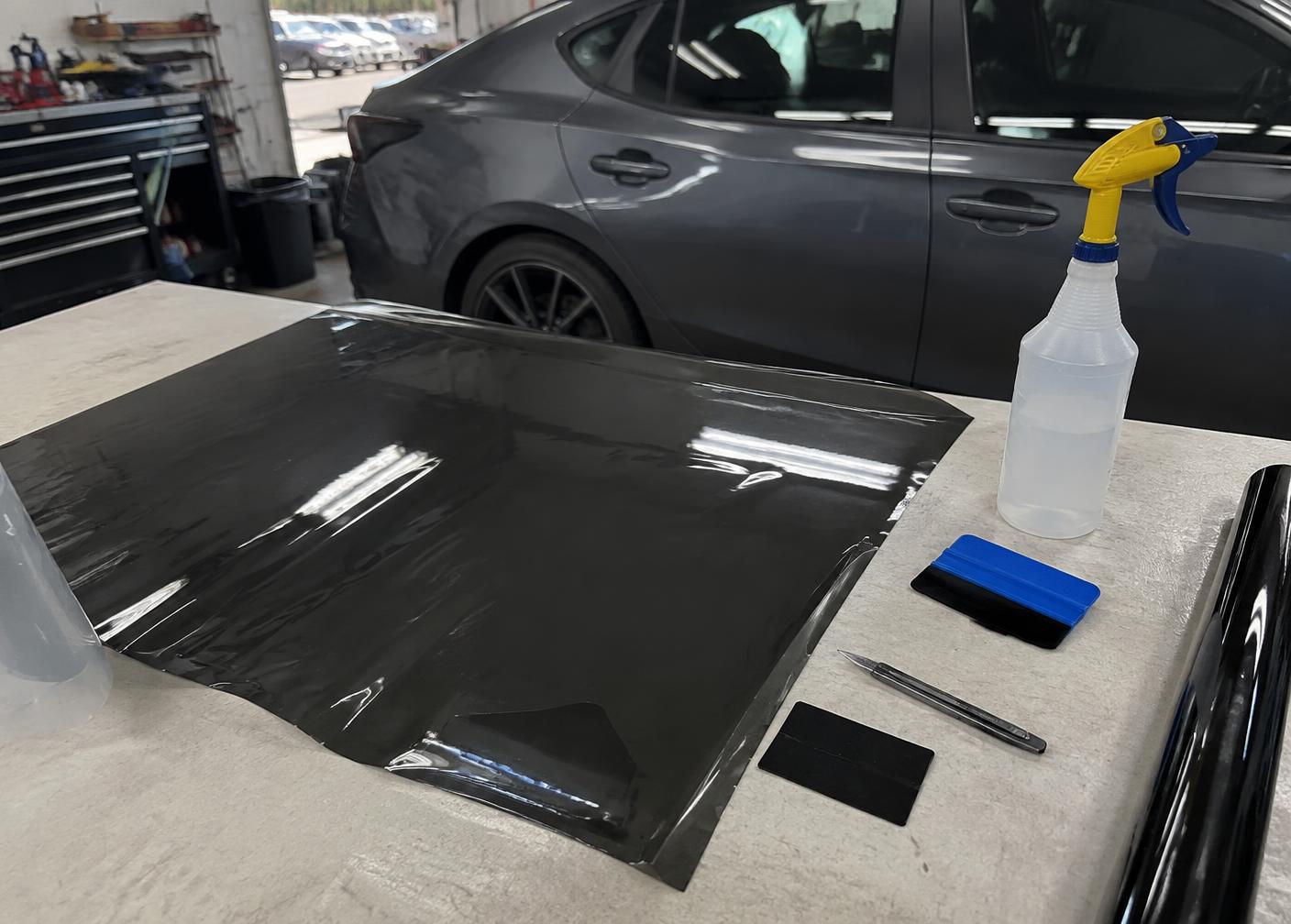 Window tint film and tools prepared on a work table