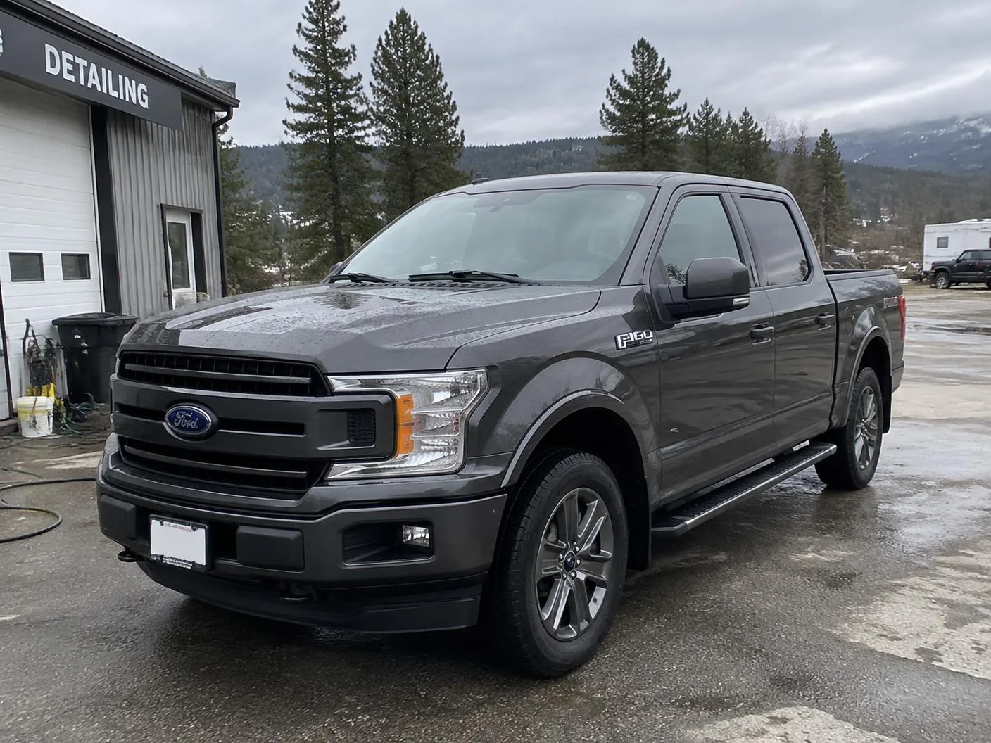 Clean dark grey pickup truck outside the Salmon Arm detailing shop