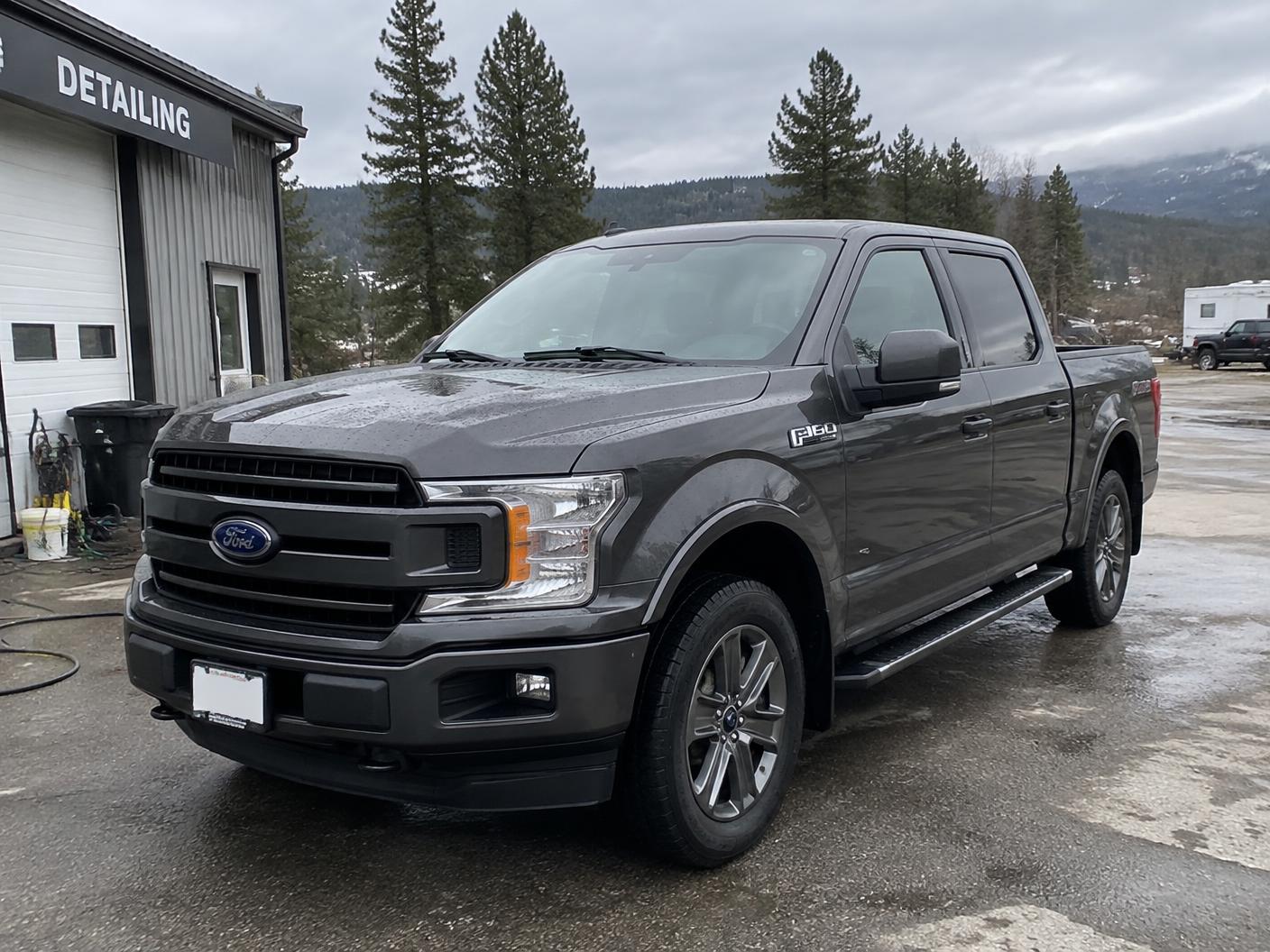 Clean dark grey pickup truck outside the Salmon Arm detailing shop