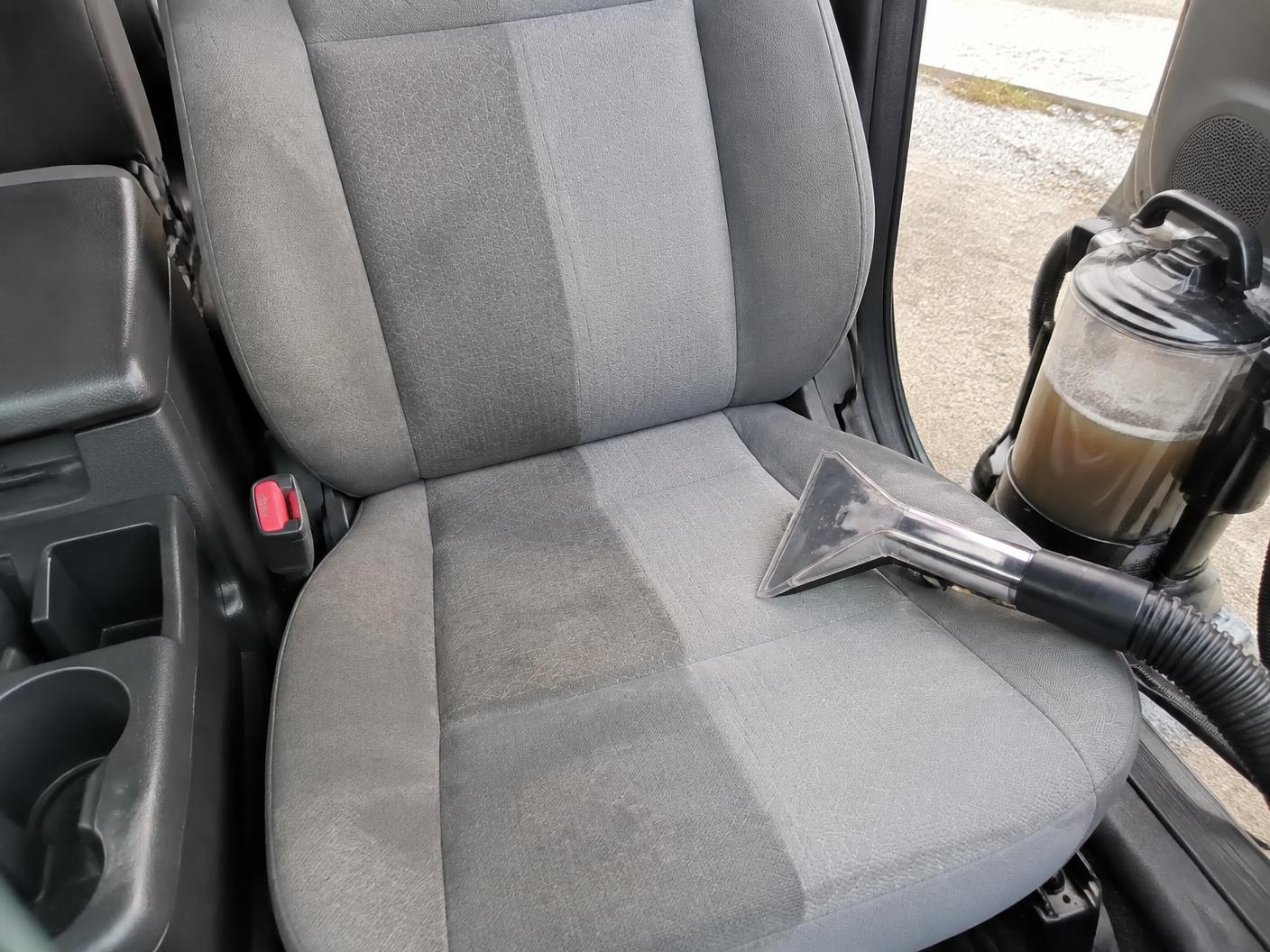 Car seat halfway through hot water extraction showing a clean line