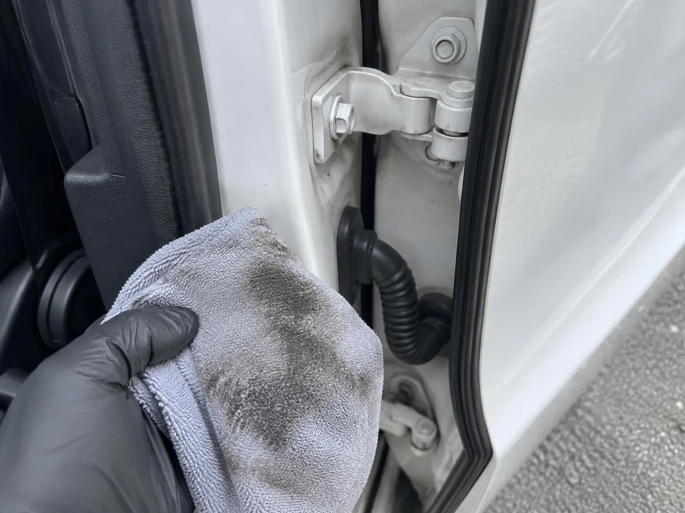Door jamb being wiped clean with a microfibre towel