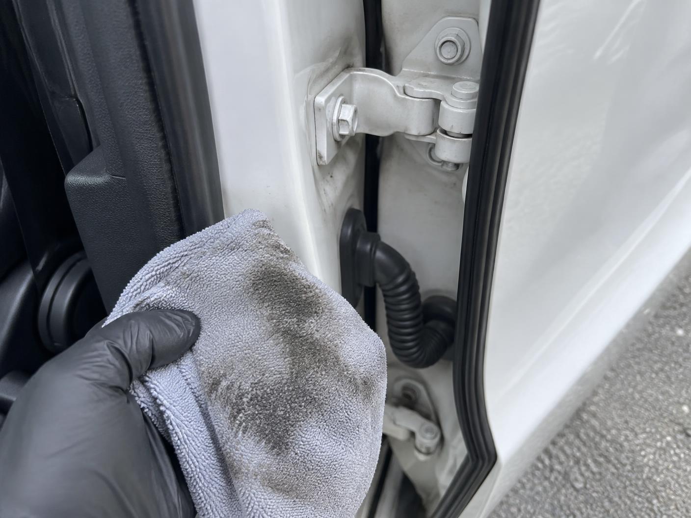 Door jamb being wiped clean with a microfibre towel